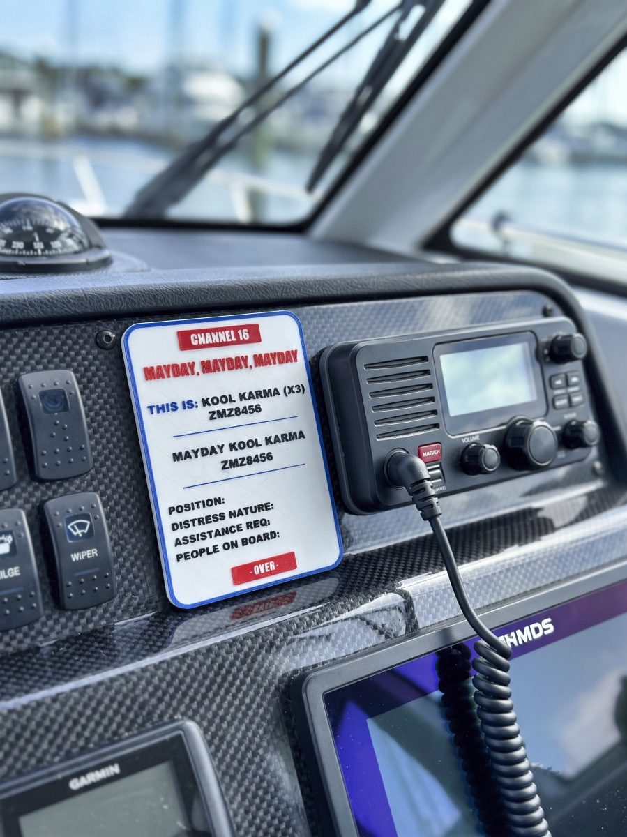 Personalised VHF Mayday distress sign mounted on a boat dashboard in New Zealand